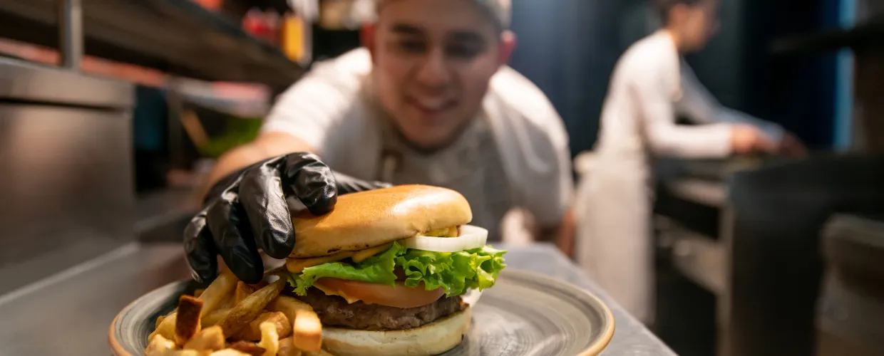 A chef fixes a burger