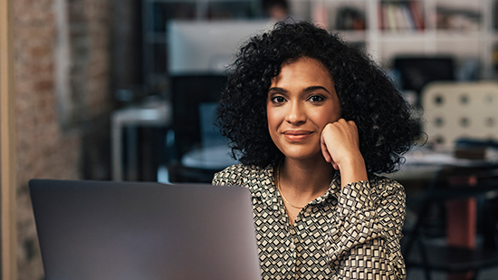 Woman smiling using a laptop